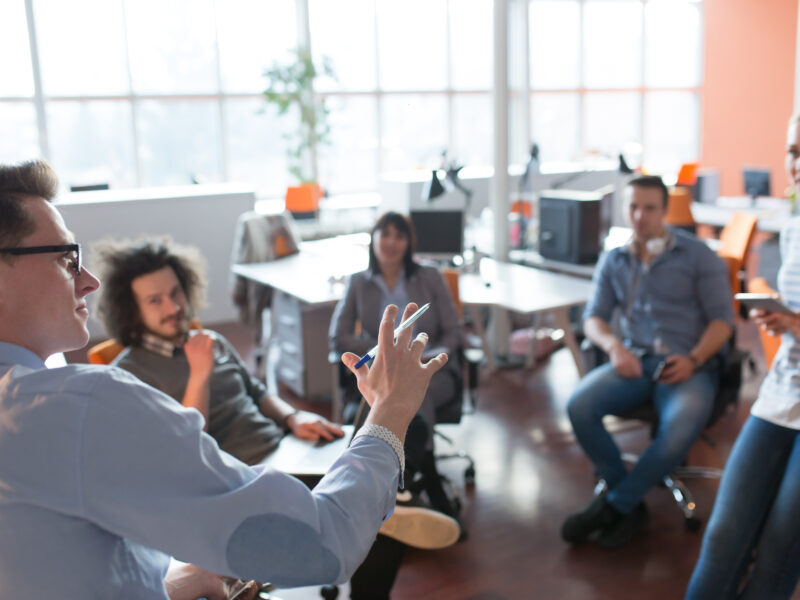 Group of a young business people discussing business plan in the office